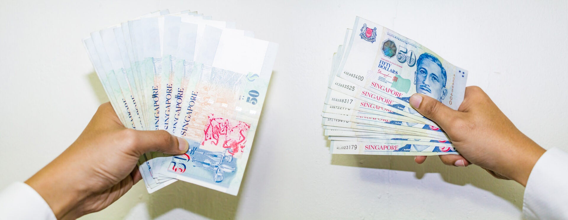 hand holding singapore dollar cash banknotes 123rf