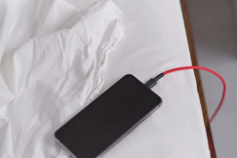 phone charging on bed 123rf