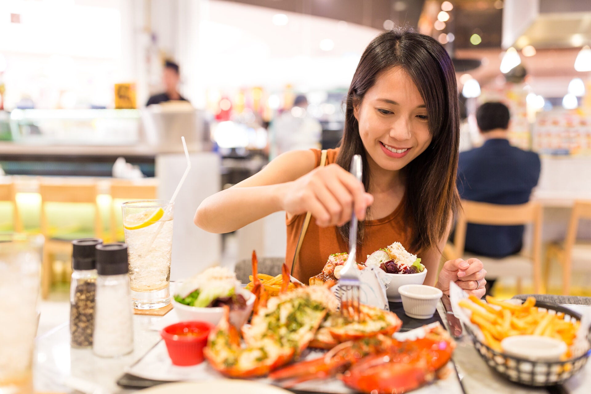 woman happy eating lobster 123rf