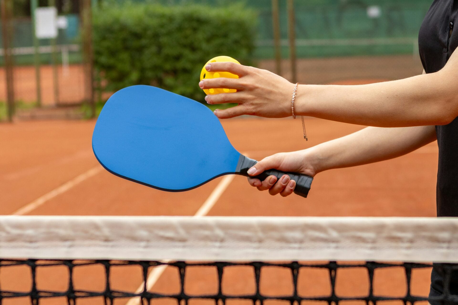 aleksander saks pickleball playing woman serve unsplash