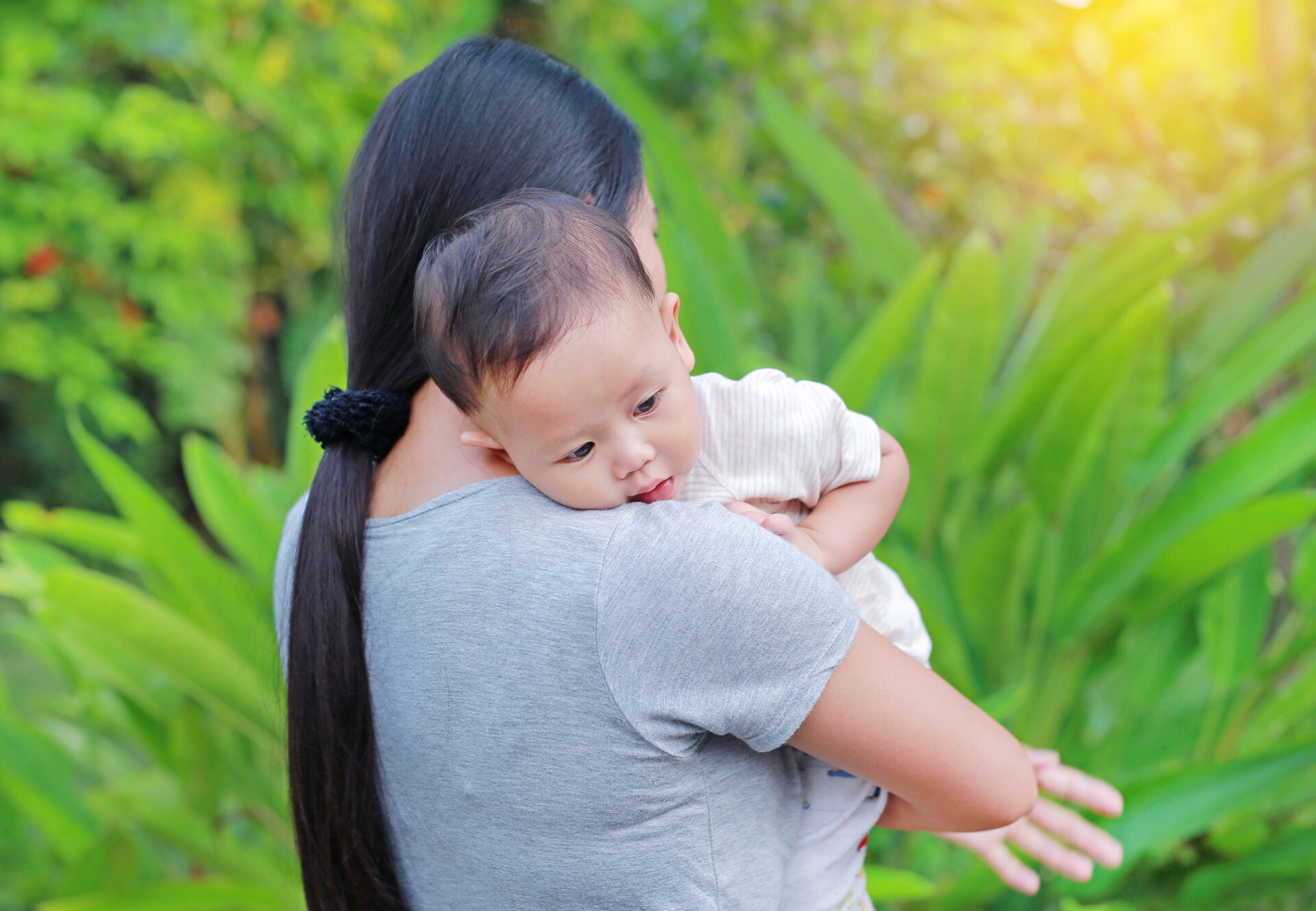 mom carrying baby 123RF