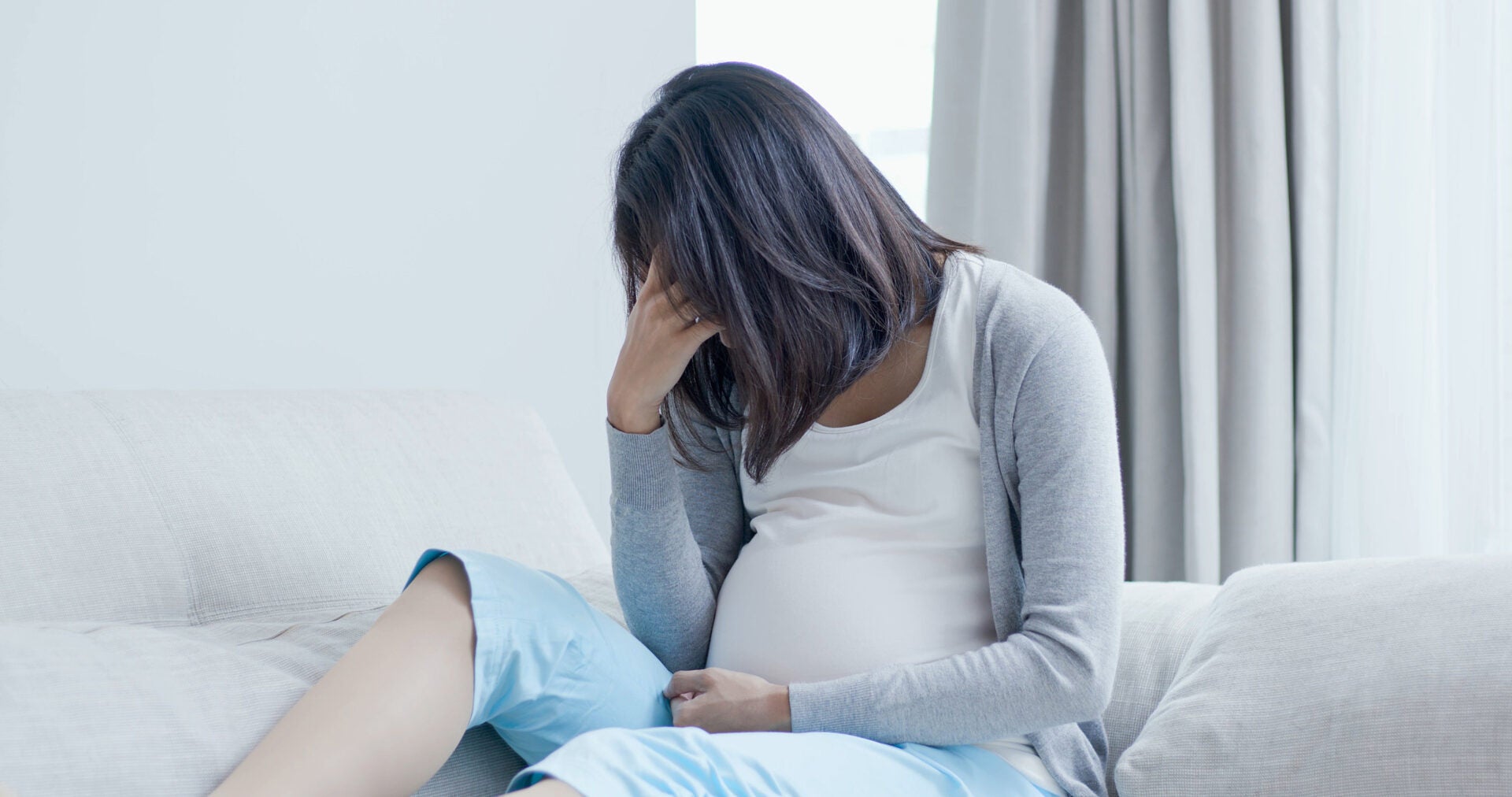 pregnant woman belly sad cover face depress 123rf