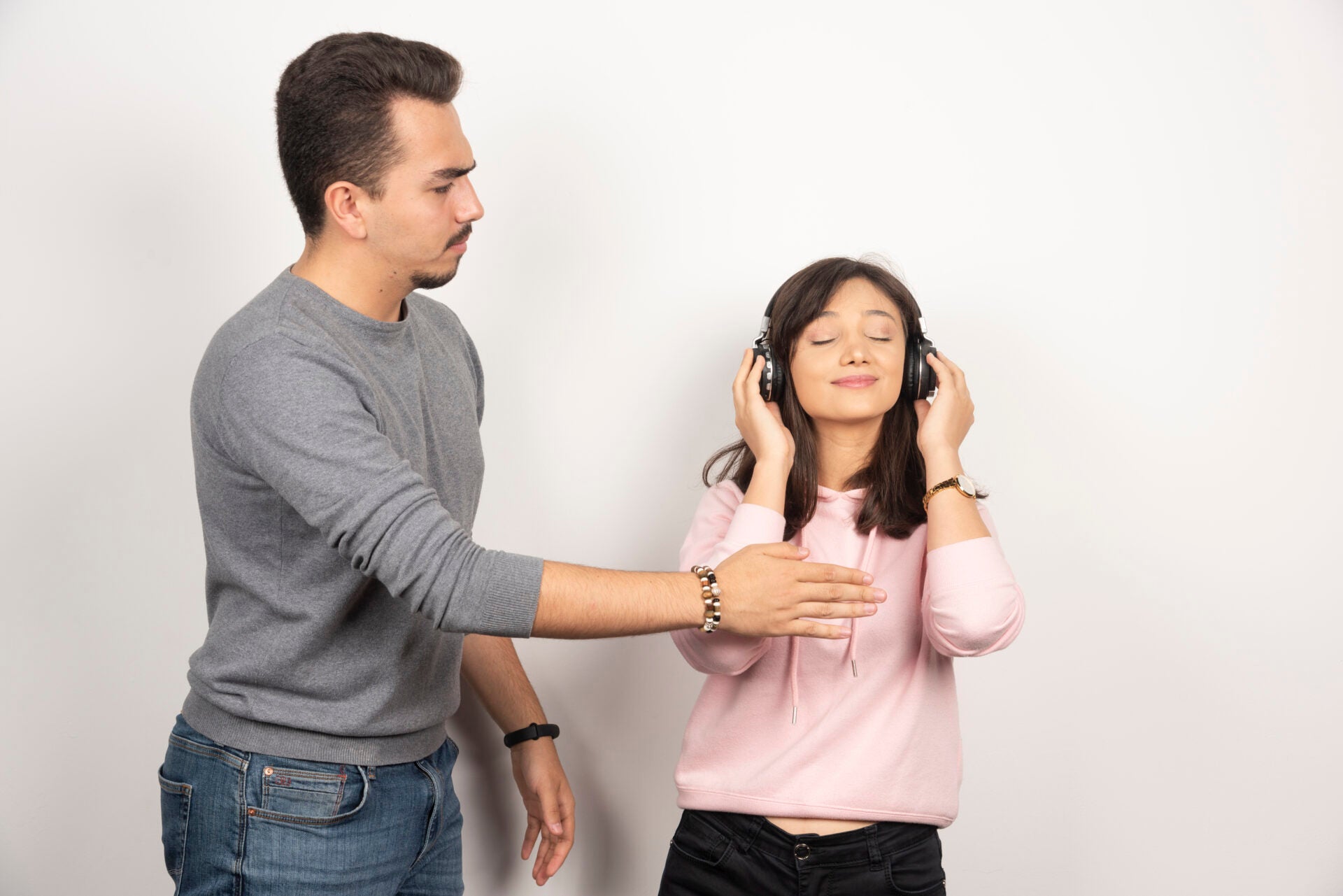 young man wants stop woman with headphone