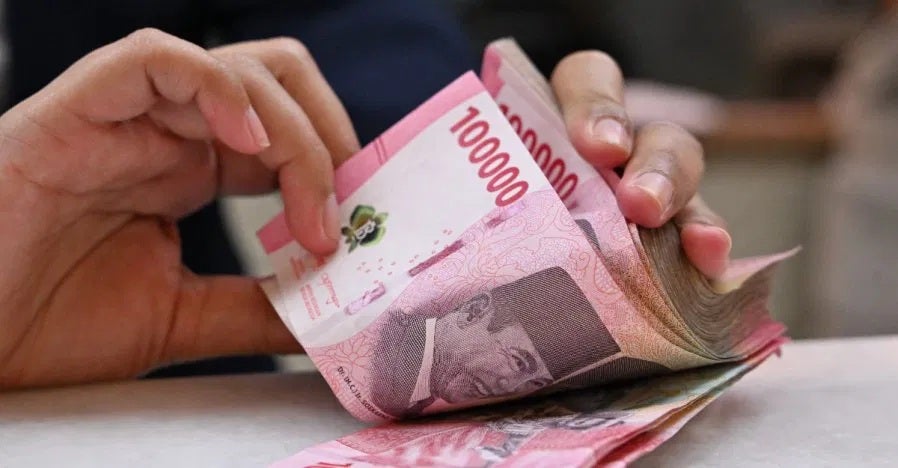 indonesian rupiah holding cash hand holding