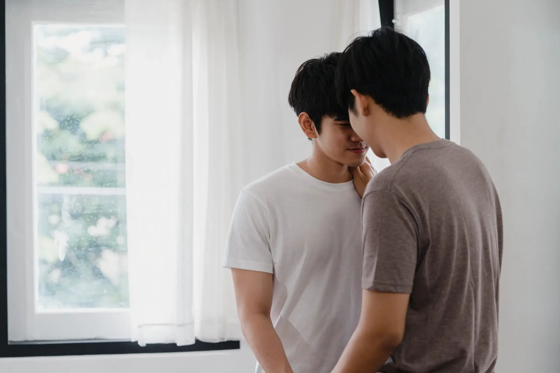 Asian Gay Couple Standing Hugging Near Window Home Young Asian Lgbtq Men Kissing Happy Relax Rest Together Spend Romantic Time Living Room Modern House Morning