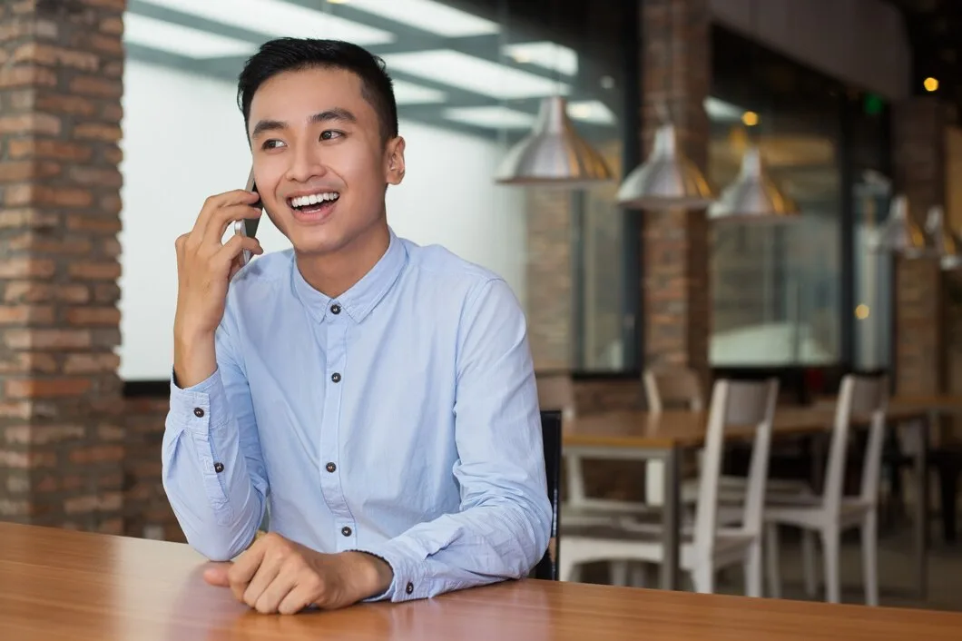Smiling Asian Man Talking Phone Cafe Table 1262 2418