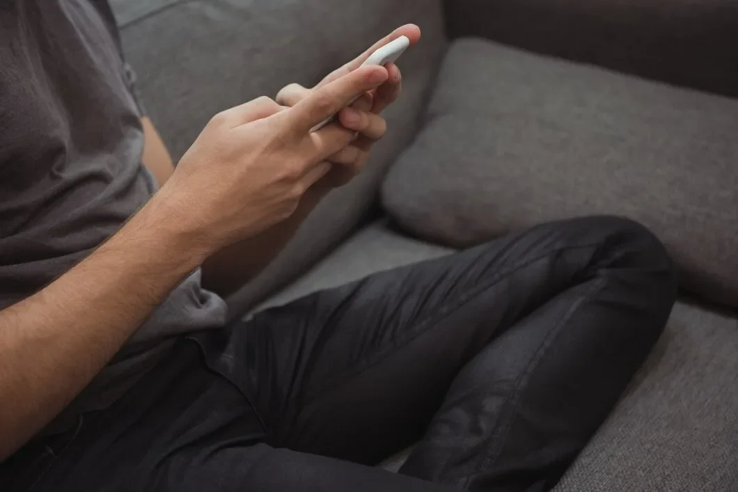 Man Using Mobile Phone Sofa 107420 96341