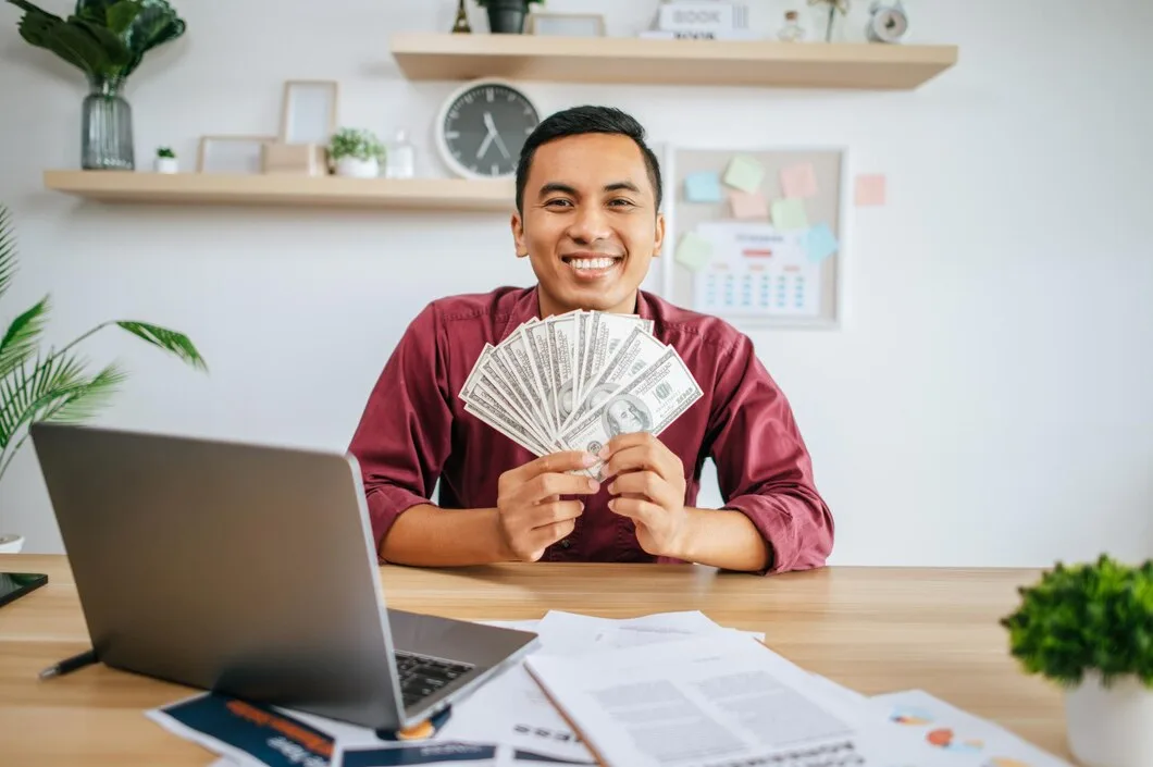 Man Working Office Holding Money With Laptop Documents Desk 1150 52076