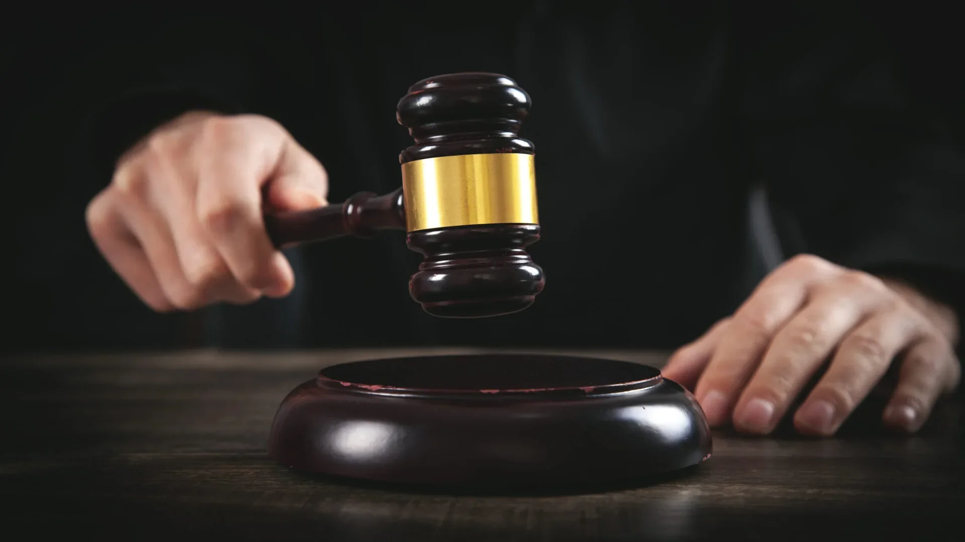 Male Judge In A Courtroom Striking The Gavel
