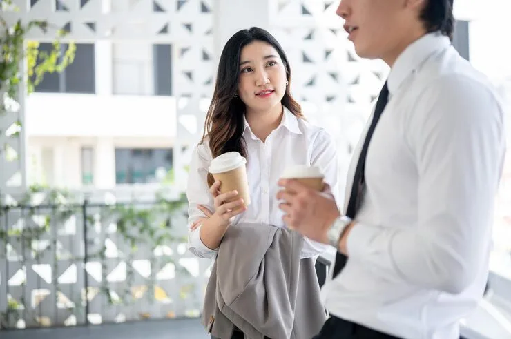 Asian Female Office Worker Male Coworker Is Holding Coffee Cup While Chatting Together 67155 55526
